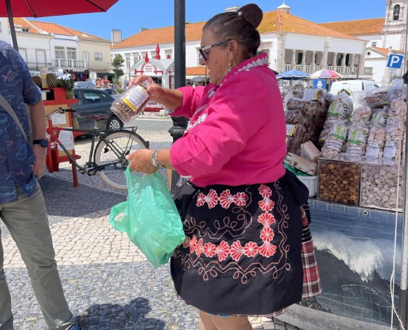 Local Portuguese women wearing traditional seven layered colorful skirts in the fishing town of Nazare