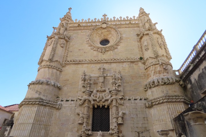 IIntricate Manueline style window and rosette decorations on the facade of the Convent of Christ in Tomar