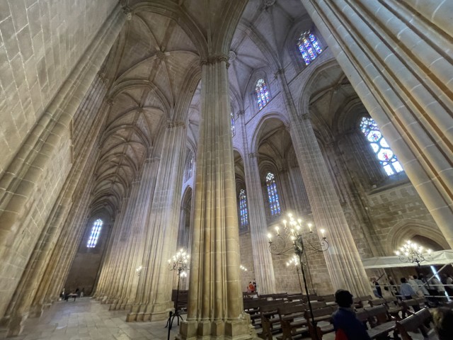 The soaring interior nave and stained glass windows of the Batalha Monastery church